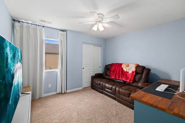 carpeted living area with visible vents, baseboards, and a ceiling fan