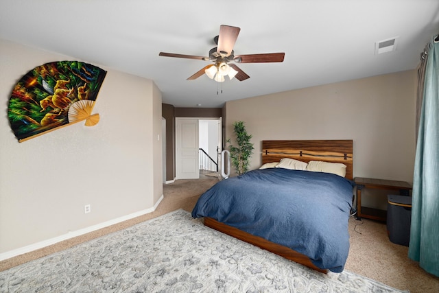 carpeted bedroom featuring visible vents, baseboards, and ceiling fan