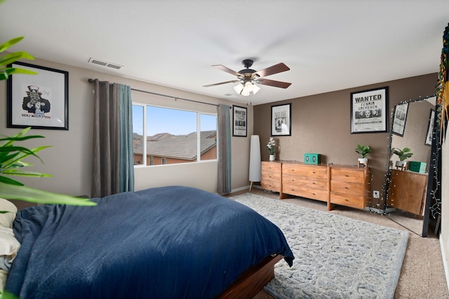 bedroom featuring carpet flooring, baseboards, visible vents, and ceiling fan