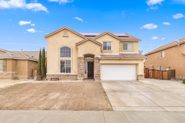 view of front of house with fence, driveway, stucco siding, stone siding, and a tiled roof