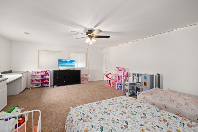 bedroom featuring ceiling fan, visible vents, and light carpet