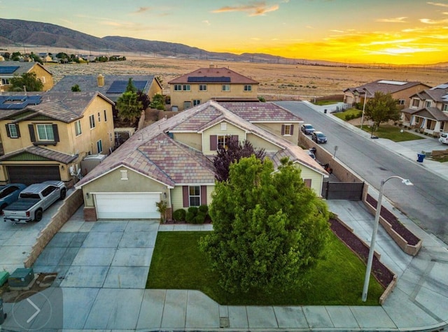 aerial view at dusk with a residential view and a mountain view