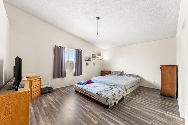 bedroom featuring a textured ceiling, lofted ceiling, and wood finished floors