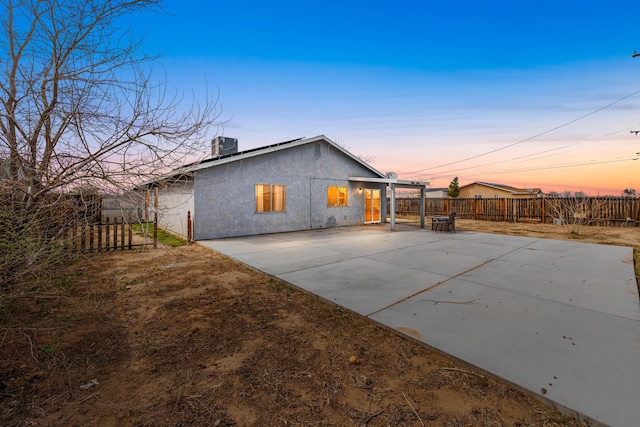 back of property with a patio, central AC unit, a fenced backyard, and stucco siding