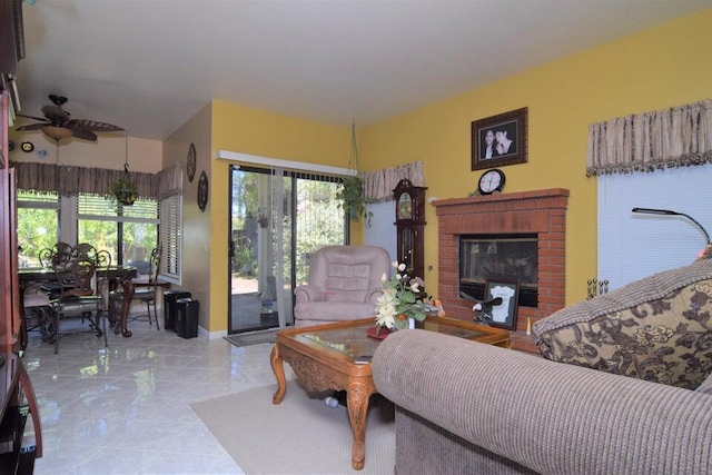 living room with a fireplace, a wealth of natural light, and ceiling fan