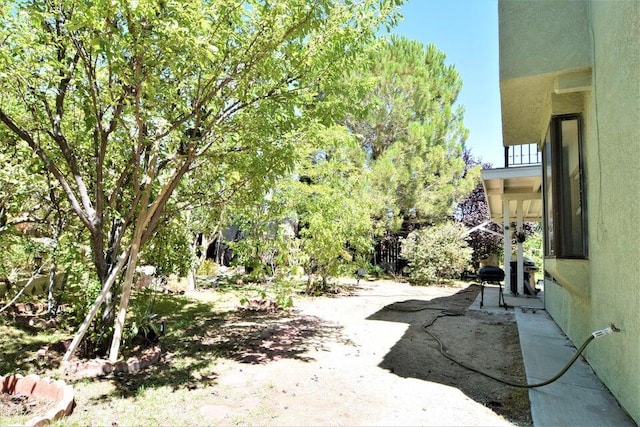 view of yard with a balcony and a patio area