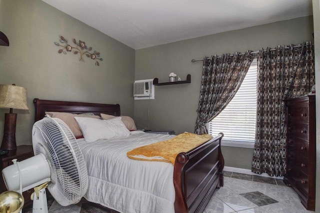 bedroom featuring light tile patterned floors and a wall mounted AC