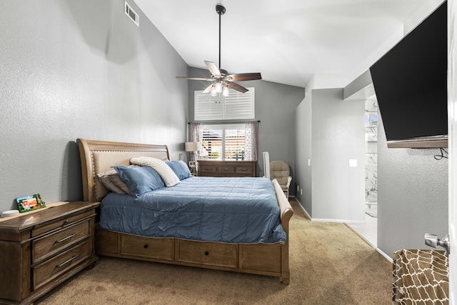 carpeted bedroom with ceiling fan and vaulted ceiling