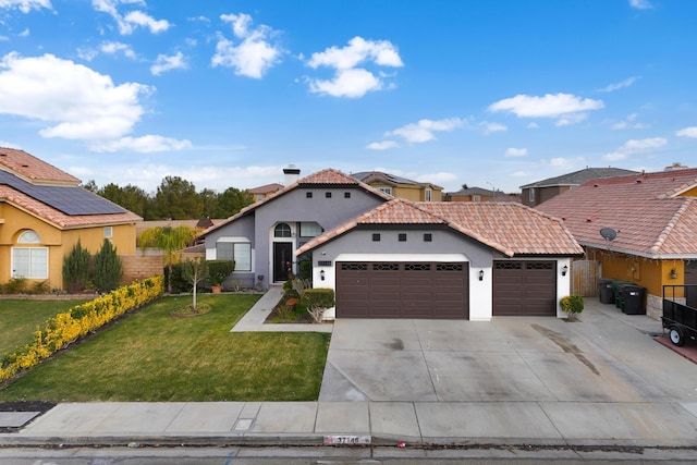 mediterranean / spanish-style house featuring a garage and a front yard