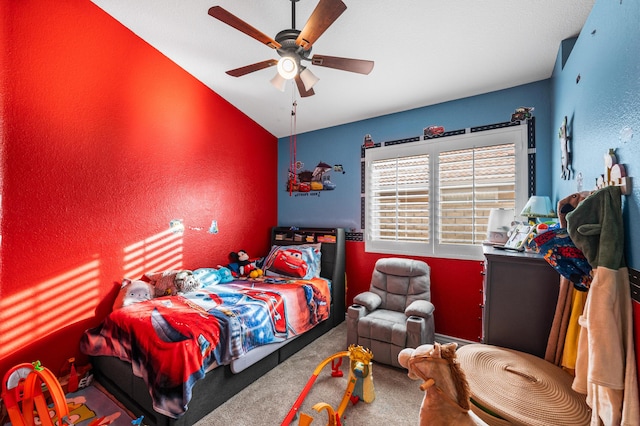 carpeted bedroom featuring ceiling fan and vaulted ceiling