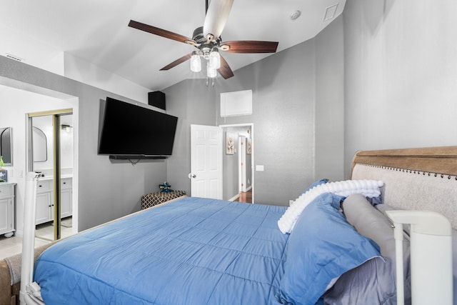 bedroom featuring ceiling fan, lofted ceiling, and connected bathroom