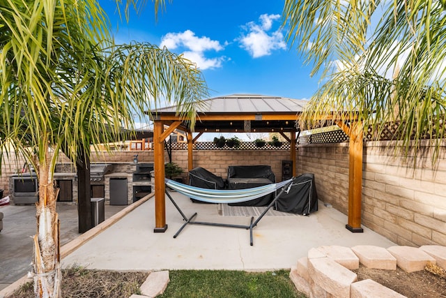 view of patio with an outdoor kitchen and a gazebo