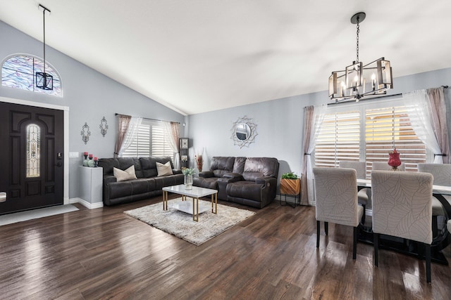 living room featuring lofted ceiling, dark hardwood / wood-style floors, and a notable chandelier