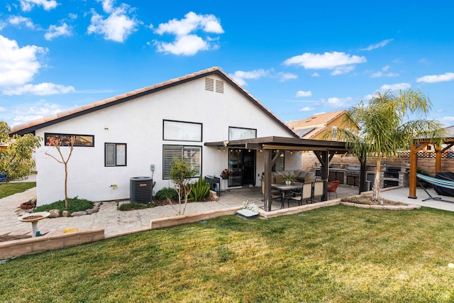 rear view of house with central AC unit, a yard, and a patio