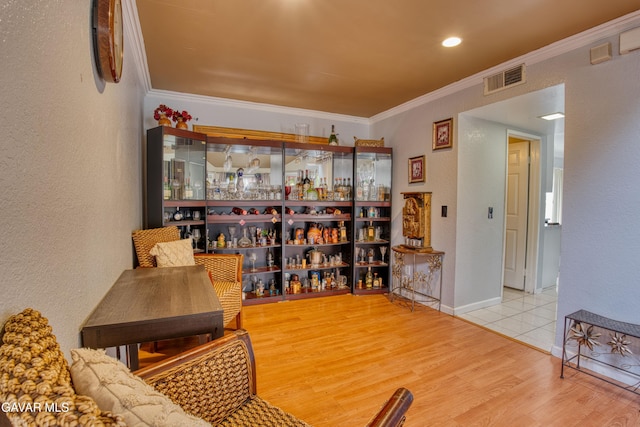 37214 Bunker Ct, Palmdale, CA 93550 - living area featuring a bar, wood finished floors, ornamental molding, and a textured wall