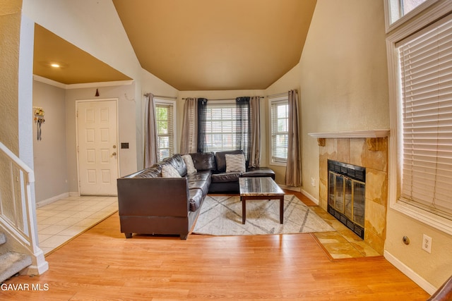 37214 Bunker Ct, Palmdale, CA 93550 - living area featuring a tiled fireplace, healthy amount of natural light, lofted ceiling, and wood finished floors