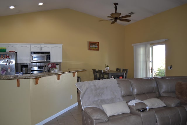living area featuring visible vents, tile patterned flooring, ceiling fan, vaulted ceiling, and recessed lighting
