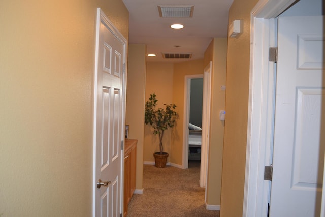hall featuring light colored carpet, visible vents, baseboards, and recessed lighting