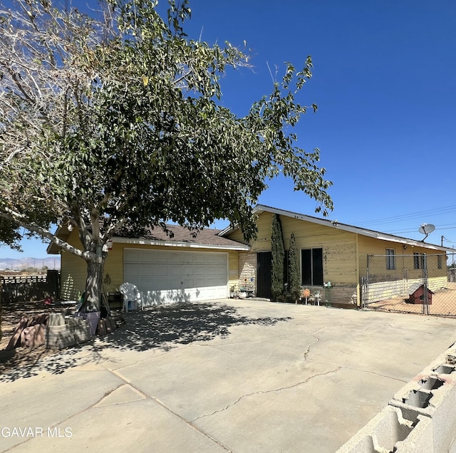 8443 Dogbane Ave, California City, CA 93505 - ranch-style house with driveway and a garage