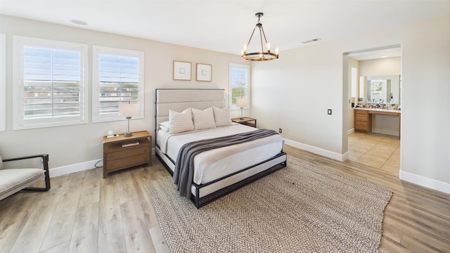 3929 Derby Cir, Quartz Hill, CA 93536 - bedroom featuring a chandelier, light wood-style floors, and baseboards