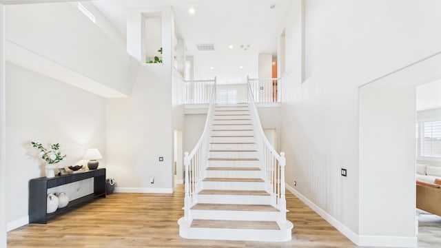 3929 Derby Cir, Quartz Hill, CA 93536 - staircase with wood finished floors, a high ceiling, baseboards, and recessed lighting