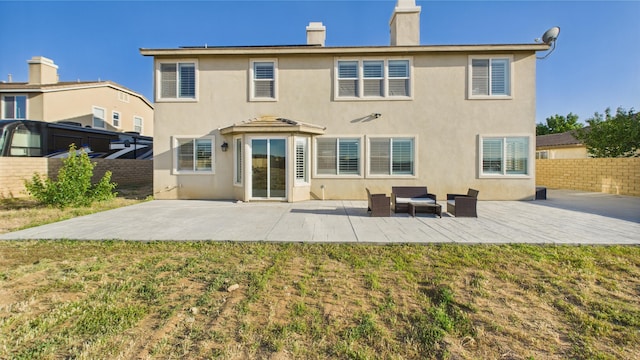 3929 Derby Cir, Quartz Hill, CA 93536 - back of house with a chimney, a patio, and stucco siding