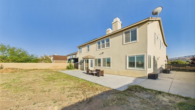 3929 Derby Cir, Quartz Hill, CA 93536 - back of house with a chimney, a patio area, central air condition unit, and stucco siding