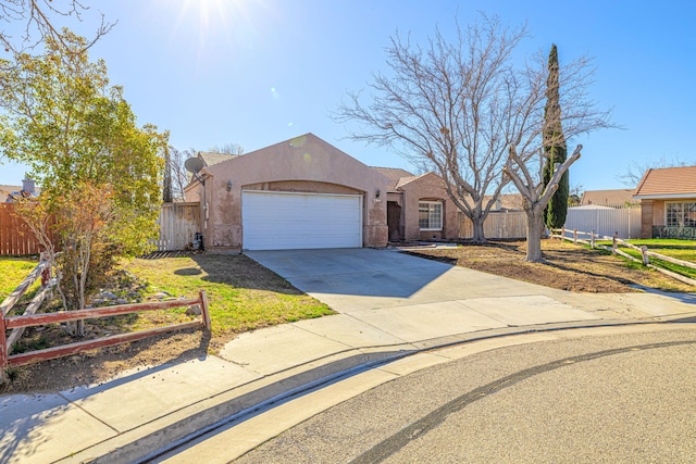 view of front of house featuring fence, a garage, driveway, and stucco siding