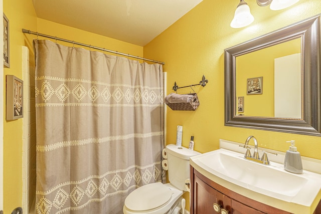 bathroom with vanity, a shower with shower curtain, and toilet