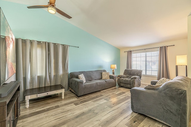 living room with a ceiling fan, light wood-style floors, and lofted ceiling