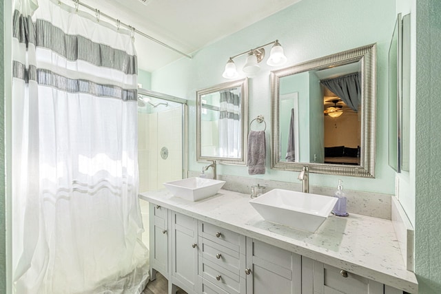 bathroom with double vanity, a shower with shower curtain, and a sink