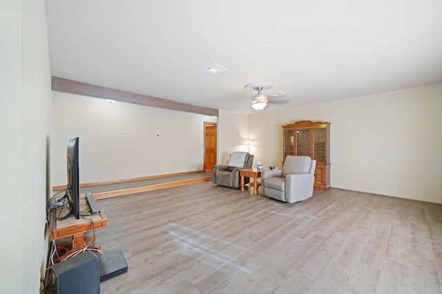 living area featuring ceiling fan and light hardwood / wood-style flooring