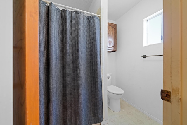 bathroom with toilet and walk in shower