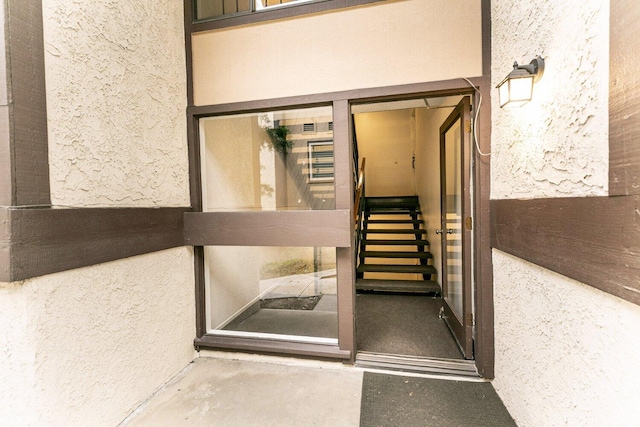 doorway to property with stucco siding