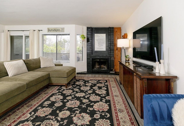 living room featuring a brick fireplace