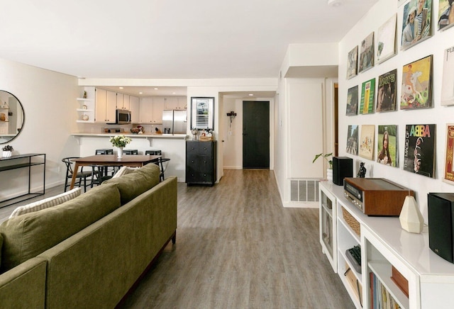 living room featuring wood finished floors and visible vents