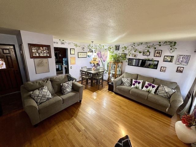 living room with hardwood / wood-style flooring and a textured ceiling