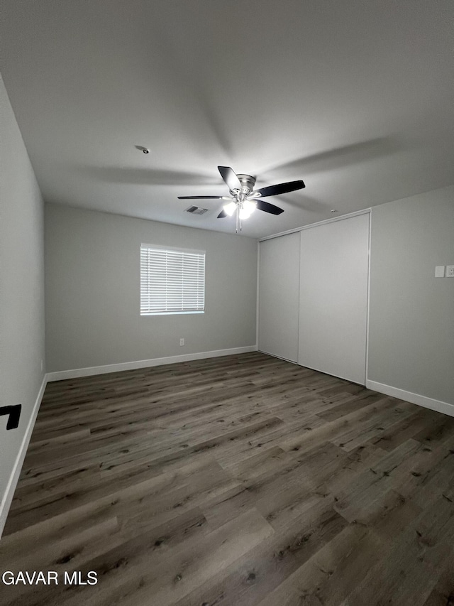10165 E E Ave Unit S10, Littlerock, CA 93543 - unfurnished bedroom with wood finished floors, a closet, and a ceiling fan
