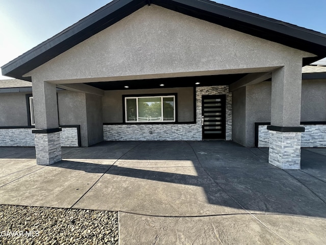 10165 E E Ave Unit S10, Littlerock, CA 93543 - view of front facade with stucco siding, stone siding, and a patio