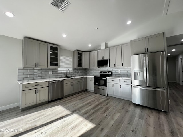 10165 E E Ave Unit S10, Littlerock, CA 93543 - kitchen featuring stainless steel appliances, gray cabinets, decorative backsplash, light countertops, and vaulted ceiling