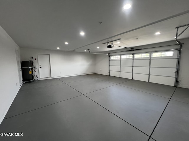 10165 E E Ave Unit S10, Littlerock, CA 93543 - garage featuring a garage door opener, recessed lighting, and water heater