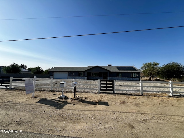 10165 E E Ave Unit S10, Littlerock, CA 93543 - ranch-style house featuring a garage, a fenced front yard, and solar panels