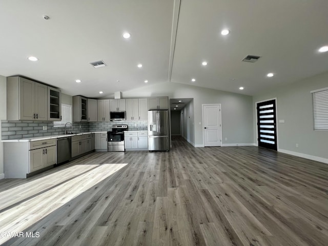 10165 E E Ave Unit S10, Littlerock, CA 93543 - kitchen with stainless steel appliances, gray cabinets, tasteful backsplash, lofted ceiling, and light countertops