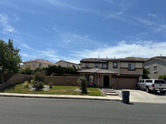 2322 Carolyn Dr, Palmdale, CA 93551 - view of front of house with driveway, a garage, and stucco siding