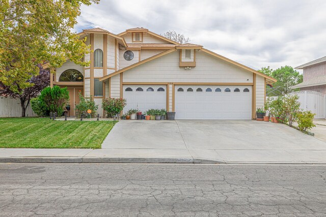 view of front of house featuring a front lawn and a garage