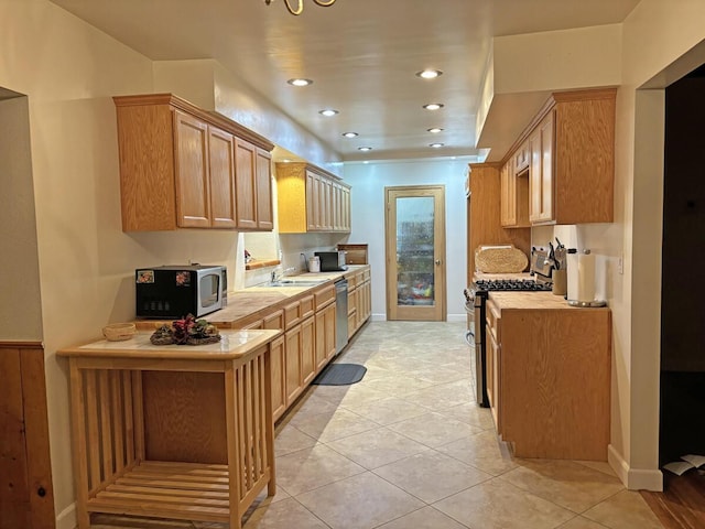 42930 Lake Hughes Rd, Lake Hughes, CA 93532 - kitchen with light brown cabinets, light tile patterned floors, sink, and appliances with stainless steel finishes