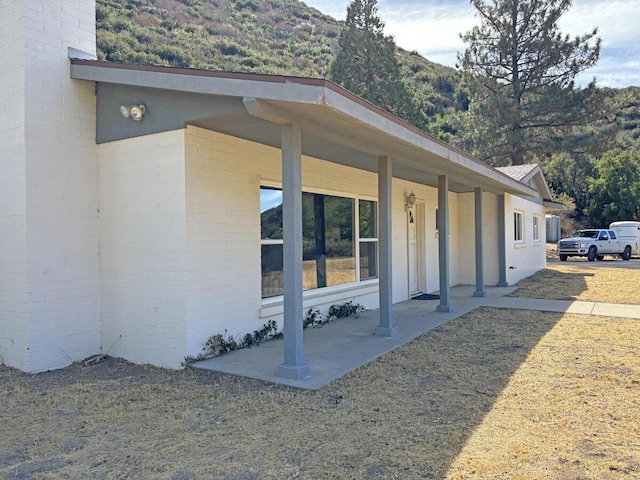 exterior space with a mountain view and a porch