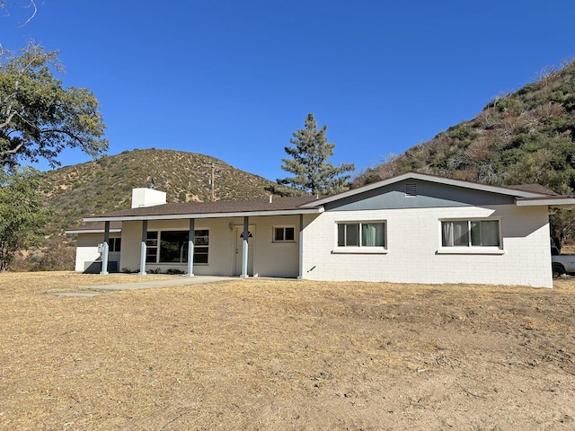 back of property with a mountain view