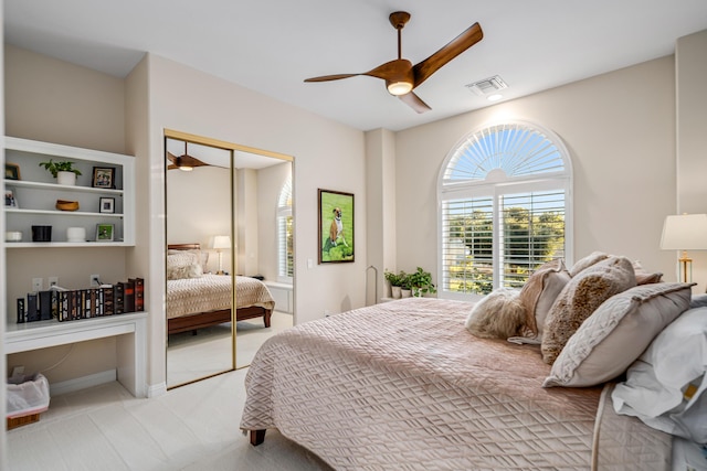 bedroom featuring ceiling fan, a closet, and light colored carpet