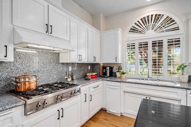 kitchen with backsplash, white cabinetry, stainless steel gas cooktop, and sink